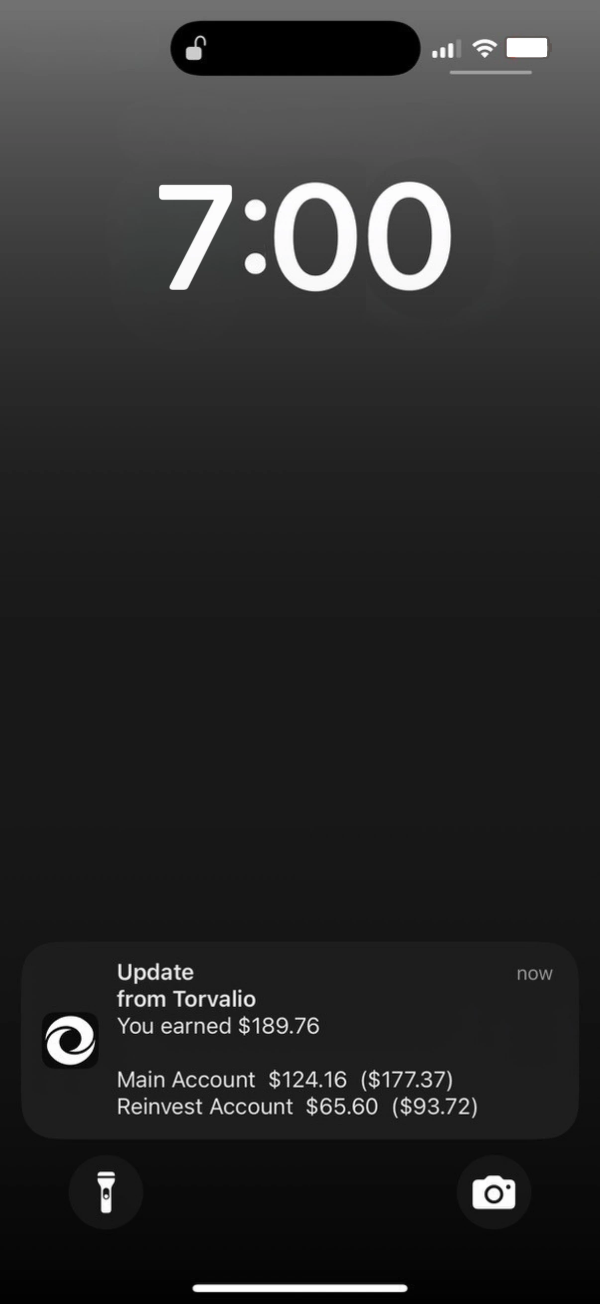 An iPhone lock screen showing a Torvalio notification: You earned $189.76, with Main Account and Reinvest Account listed underneath.